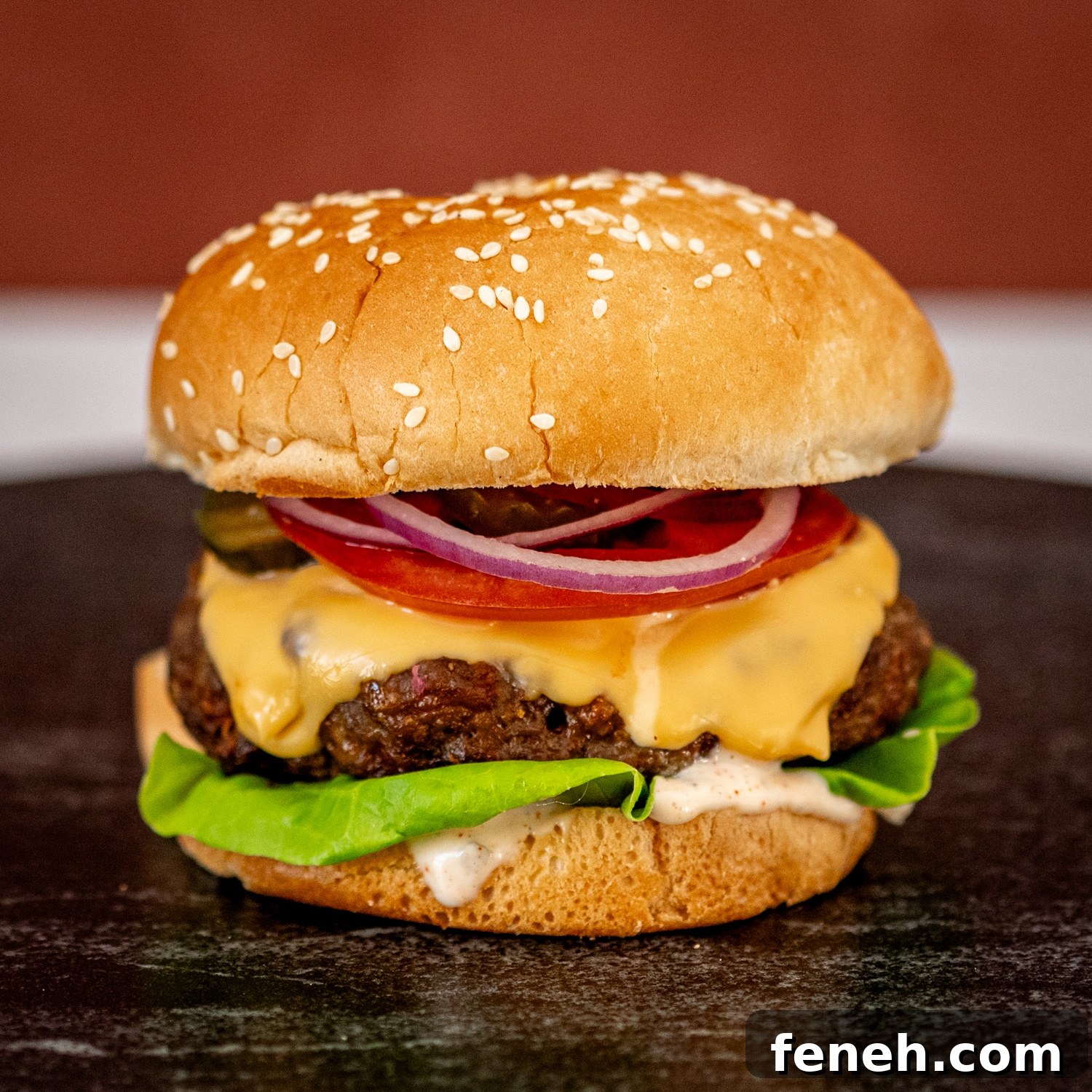 Instant Pot burger in a sesame seed bun with cheese and toppings.