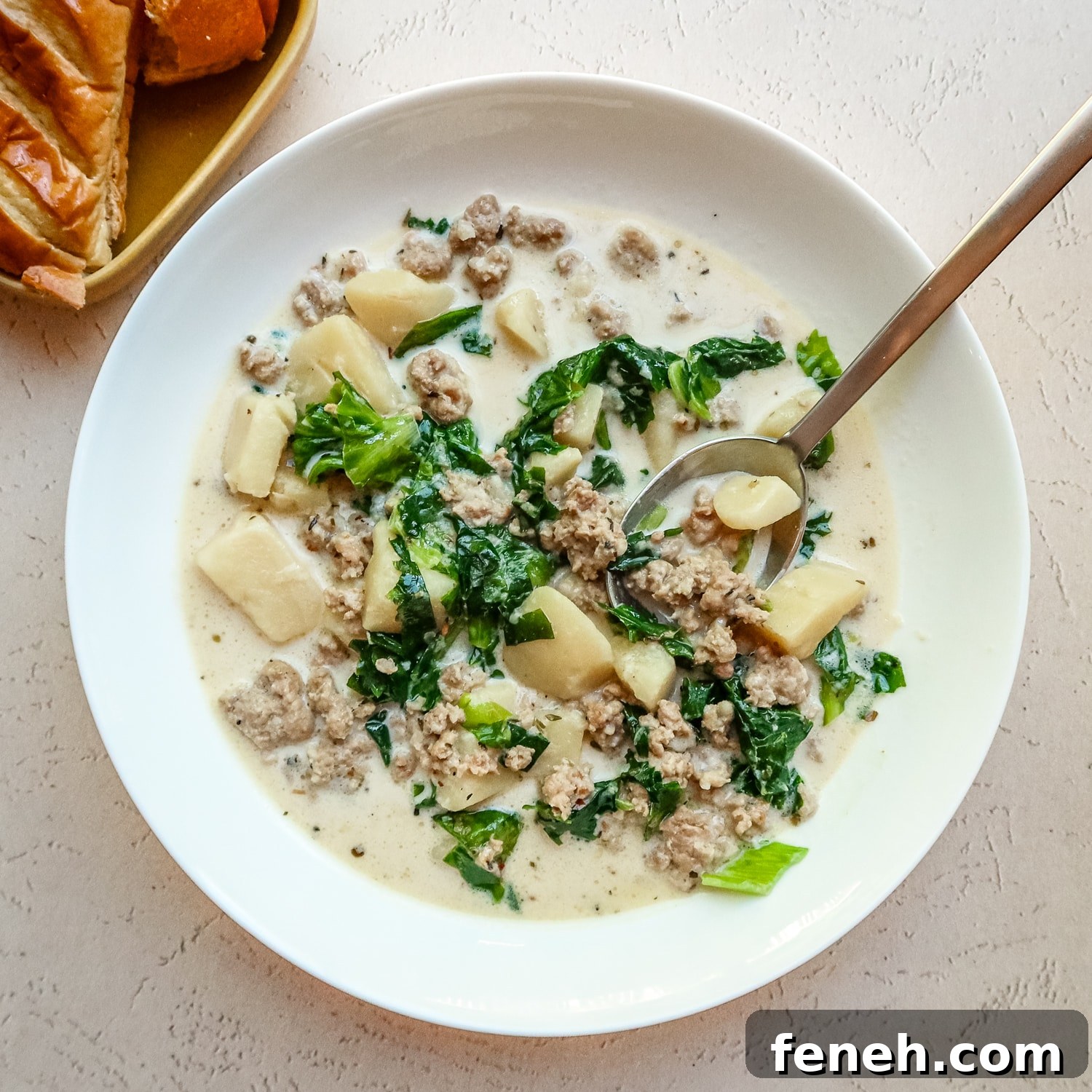 A bowl of Instant Pot zuppa Toscana, potato and sausage soup.
