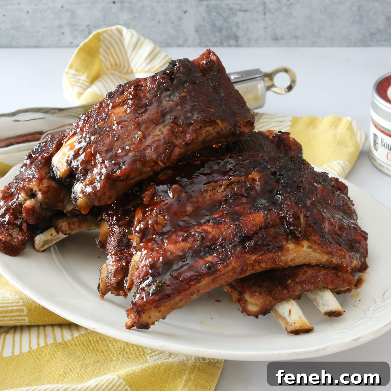 A platter of pressure cooked baby backed ribs slathered with BBQ sauce.