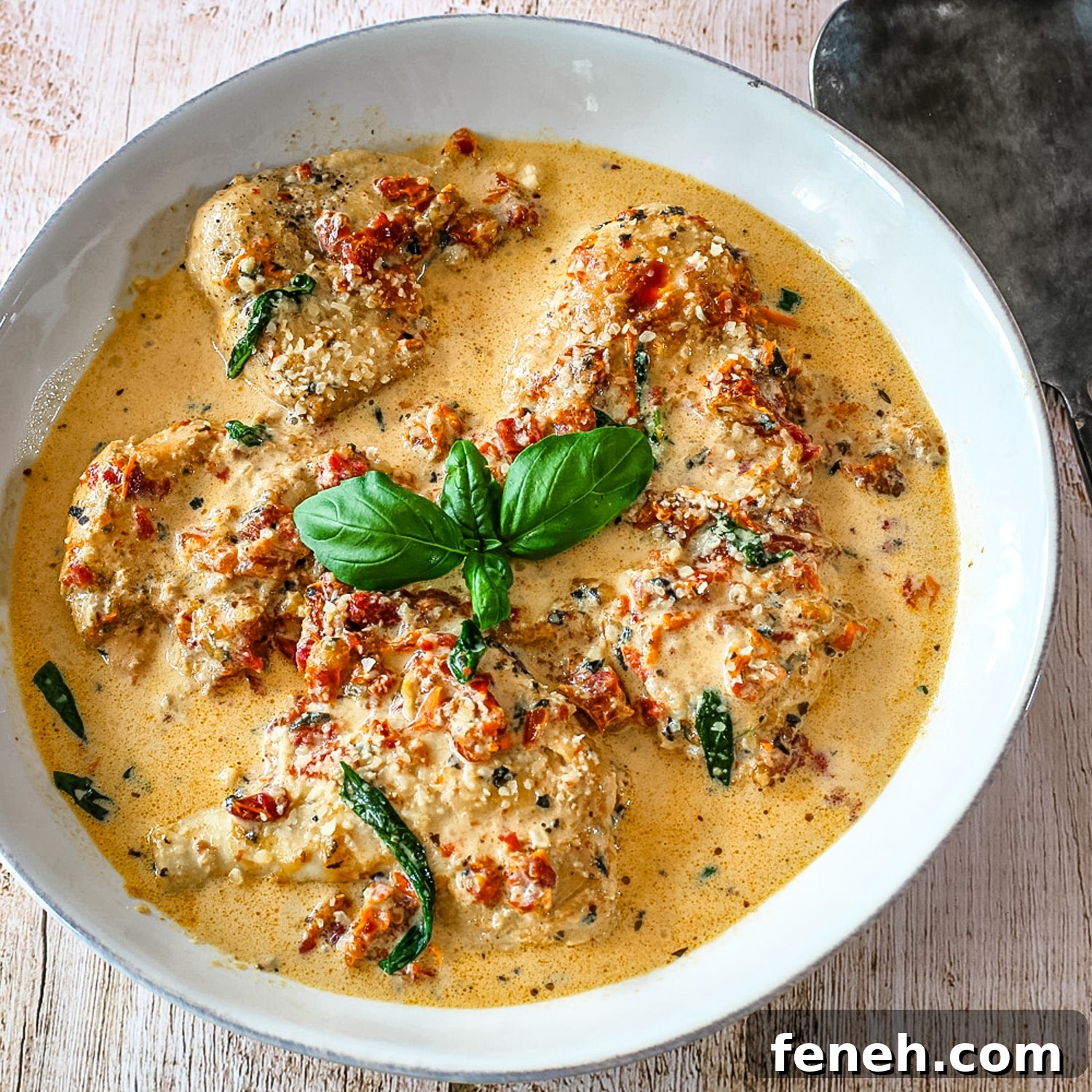 A bowl of Tuscan chicken made in the Instant Pot pressure cooker.
