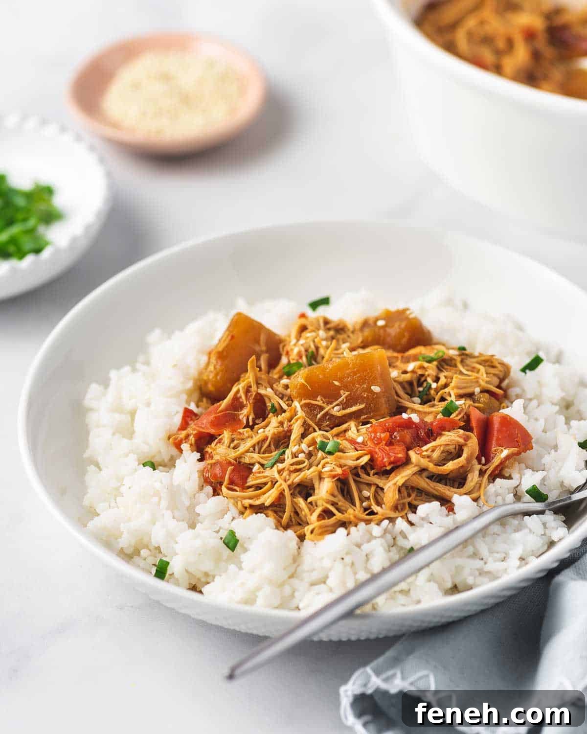 A plate of rice and crockpot pineapple chicken with a spoon in the plate.