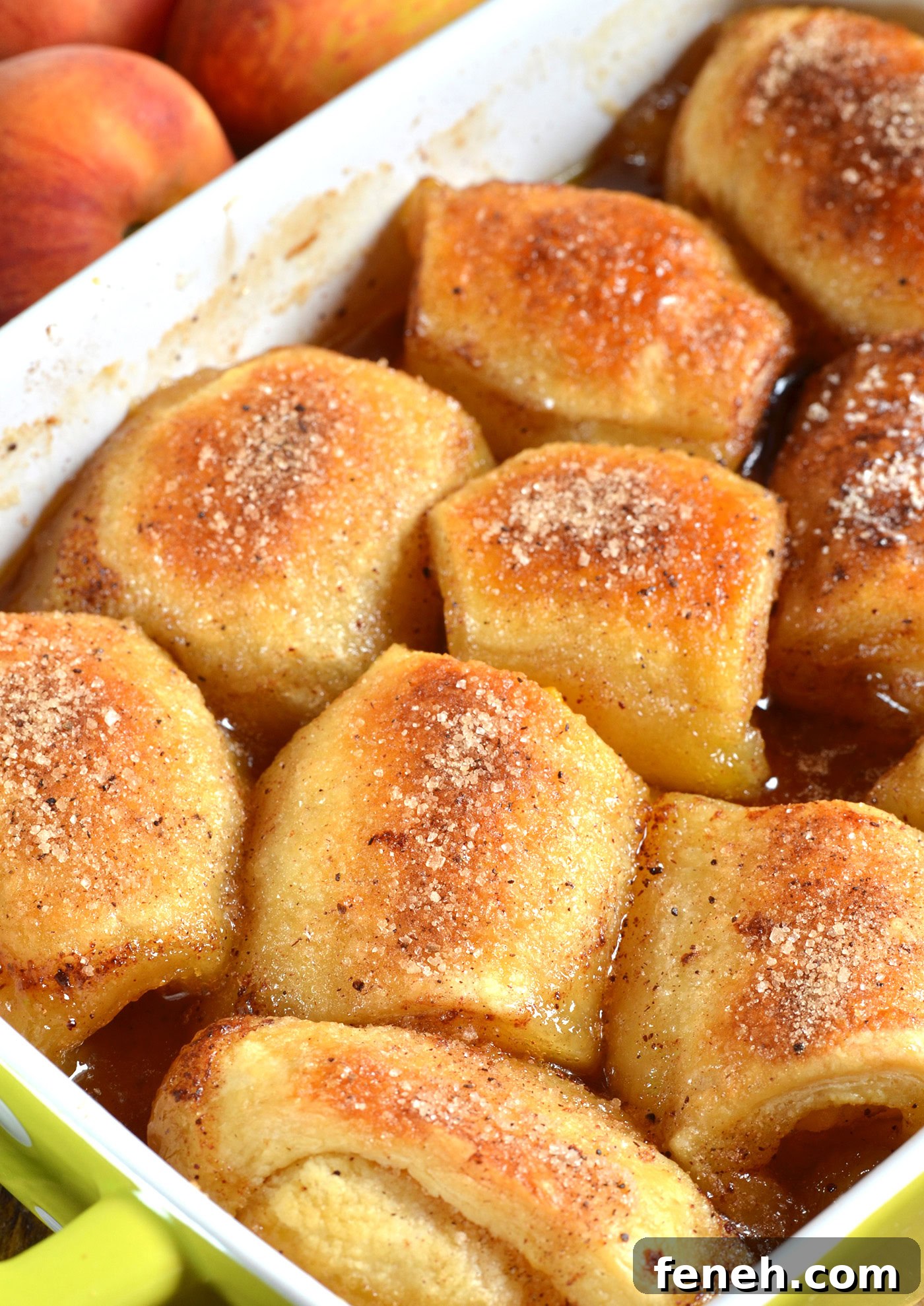 Baked peach dumplings with crescent rolls in caramel sauce, soft and buttery with cinnamon sugar topping
