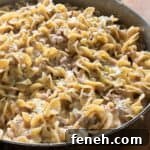 close up of creamy sausage pasta in pan