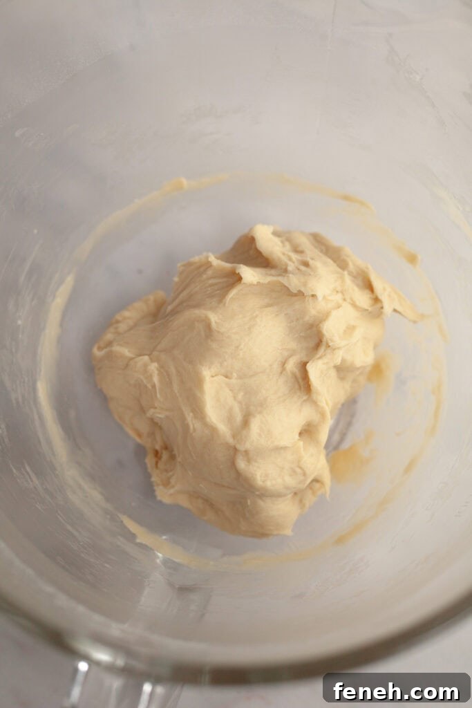 Cinnamon roll dough in a glass bowl.