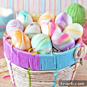 Colorful pastel truffles shaped like eggs in a woven Easter basket.