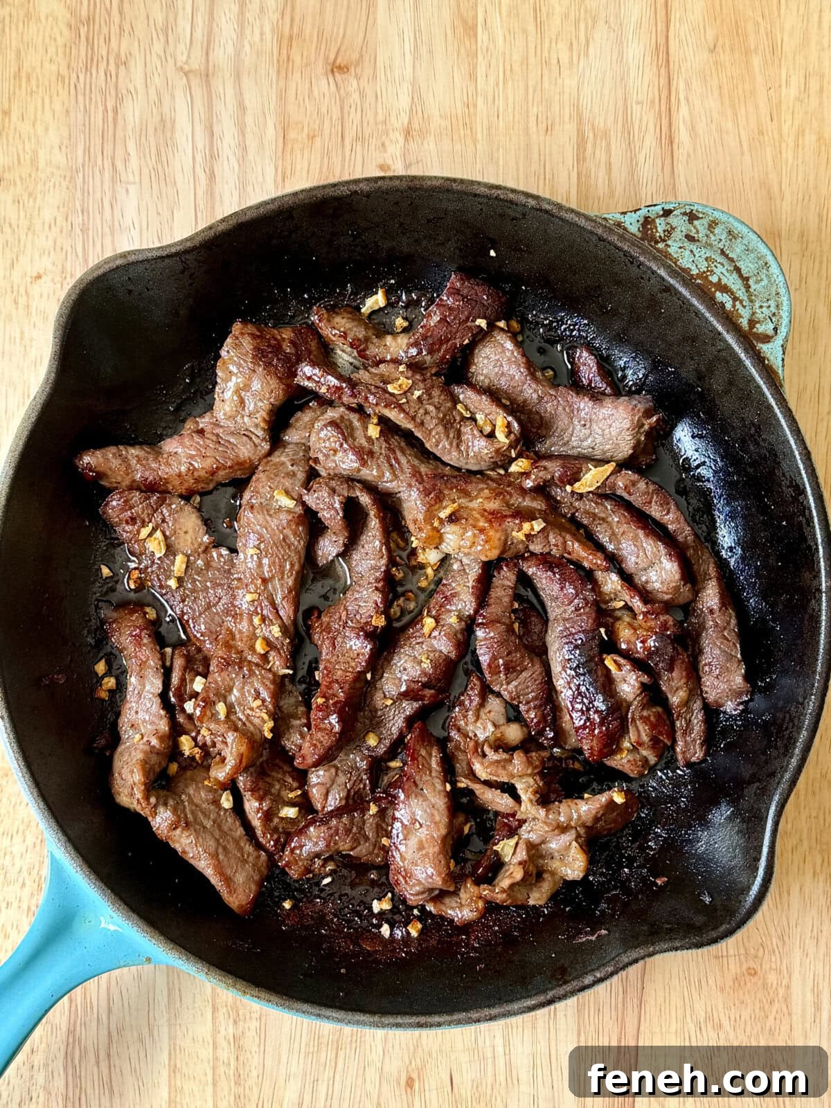 Beef Salpicao (Filipino Garlic and Butter Steak Bites) in a cast iron skillet