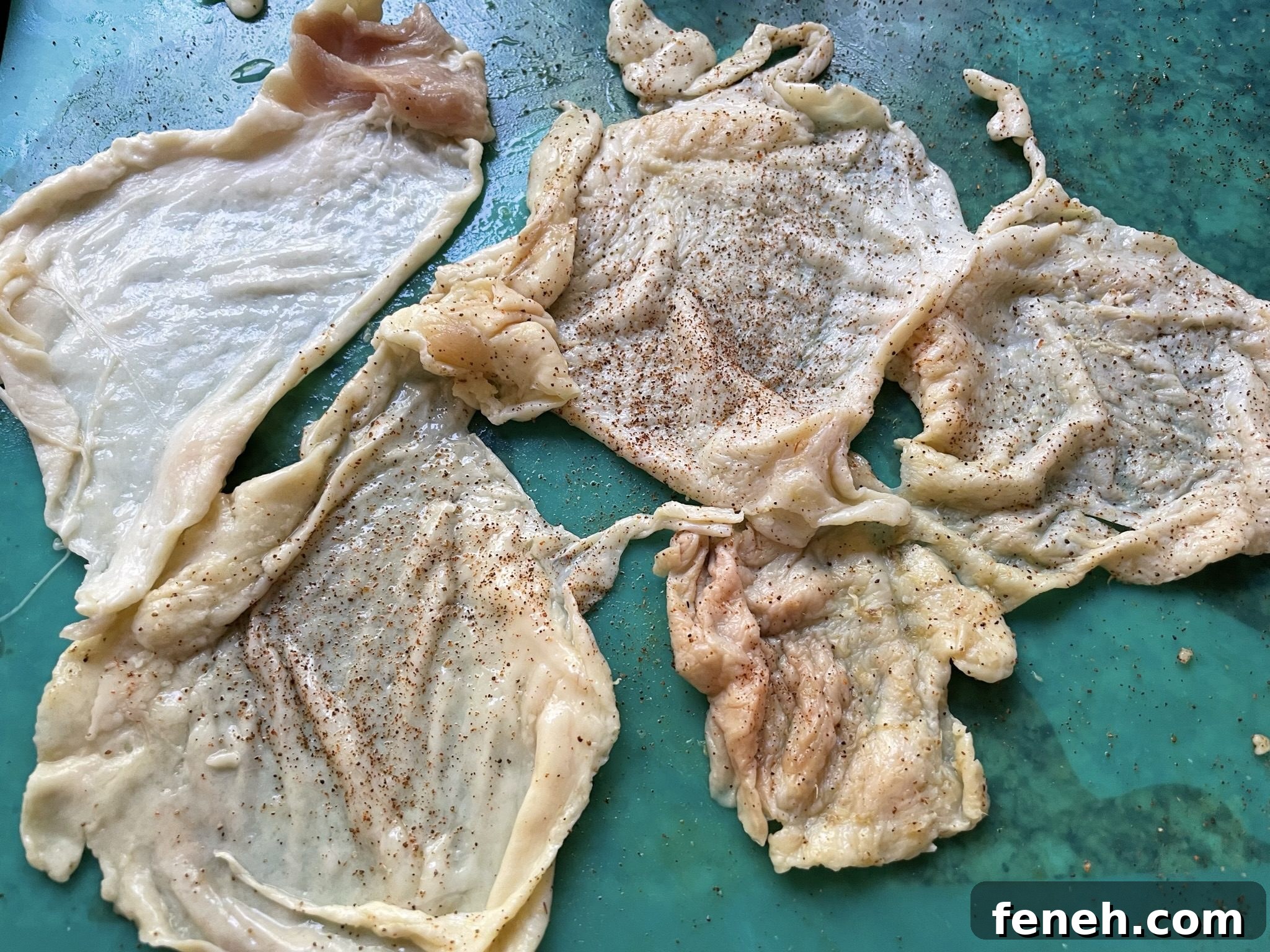 Season each chicken skin