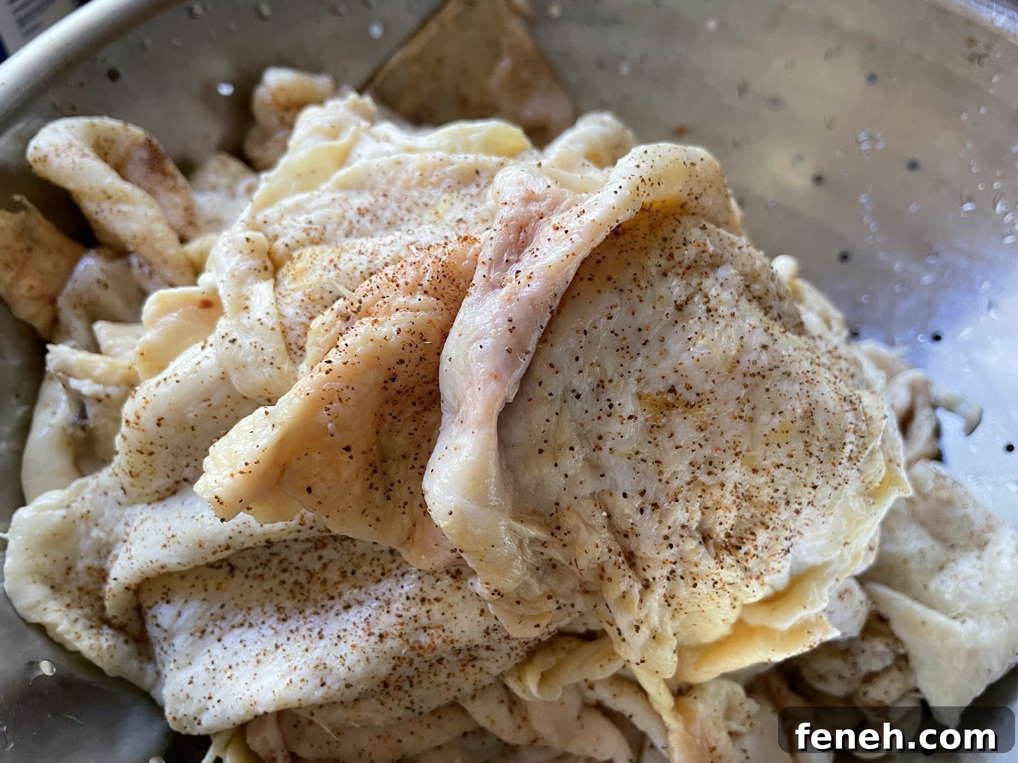 Stacked seasoned chicken skins.