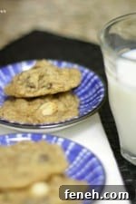 Two plates each with two Caramel Apple Chocolate Chip Cookies next to a glass of milk