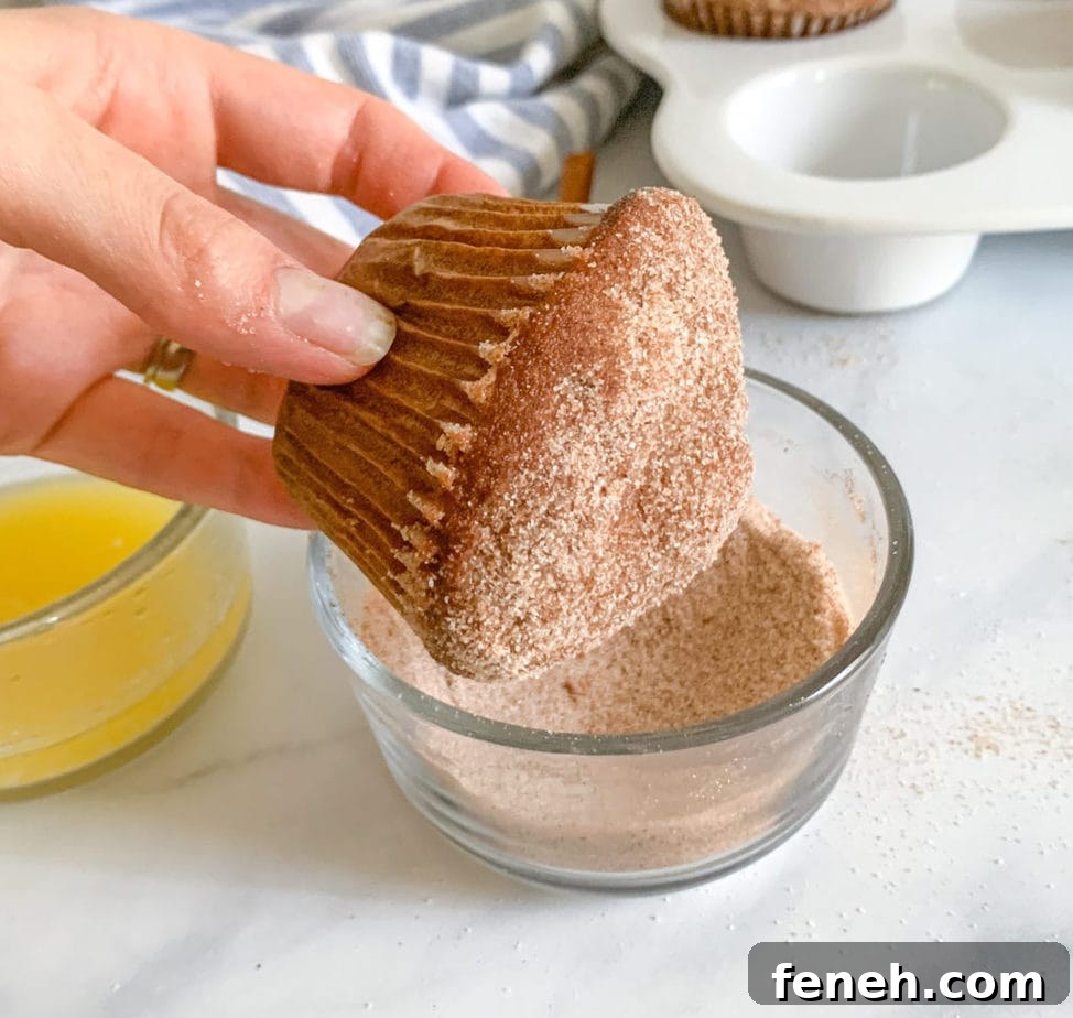 After dipping in butter, roll muffins in cinnamon sugar