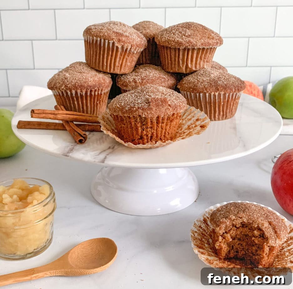 A cake stand topped with a mountain of muffins.