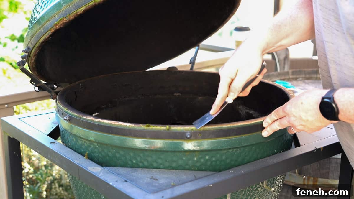 Replace the Gasket on a Big Green Egg Without Taking Off the Lid 4 Using a scraper to clean edges of a Big Green Egg before replacing the gasket.