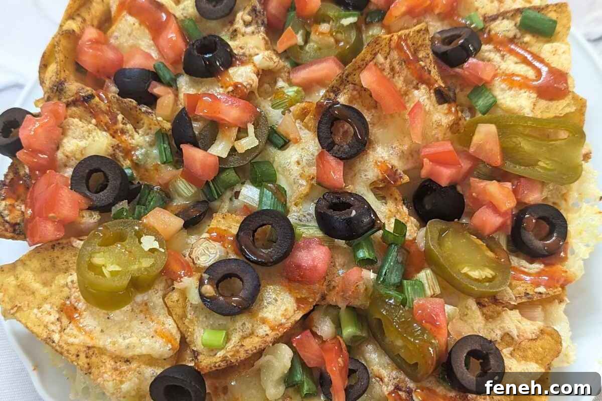 Close up of loaded nachos on a plate