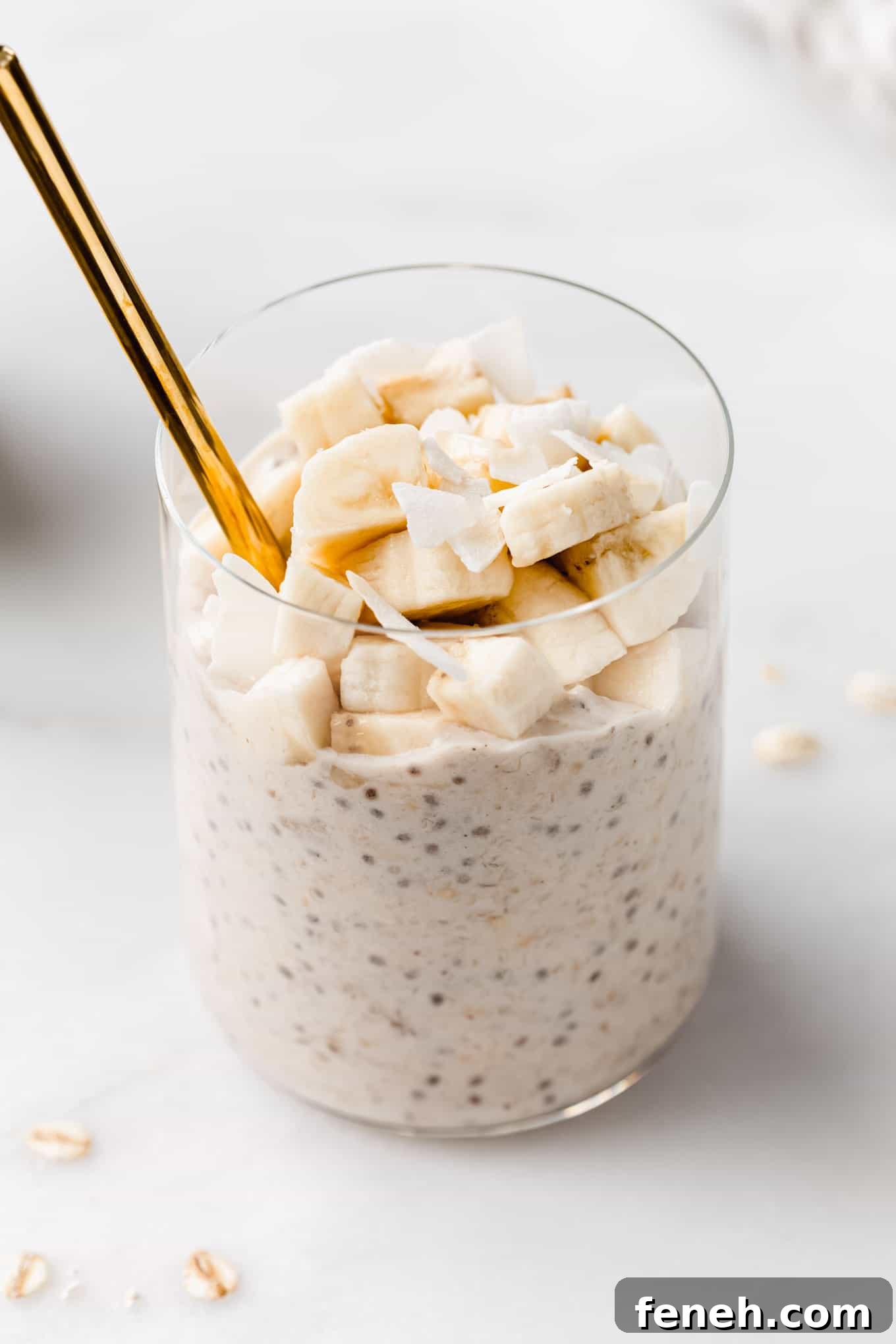 banana overnight oats in a cup with a gold spoon