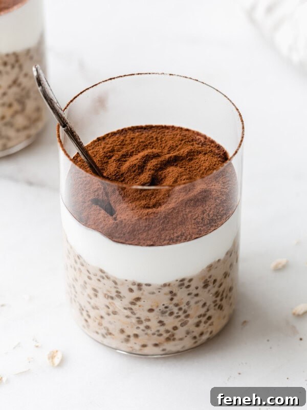 Tiramisu overnight oats in a cup topped with cocoa powder