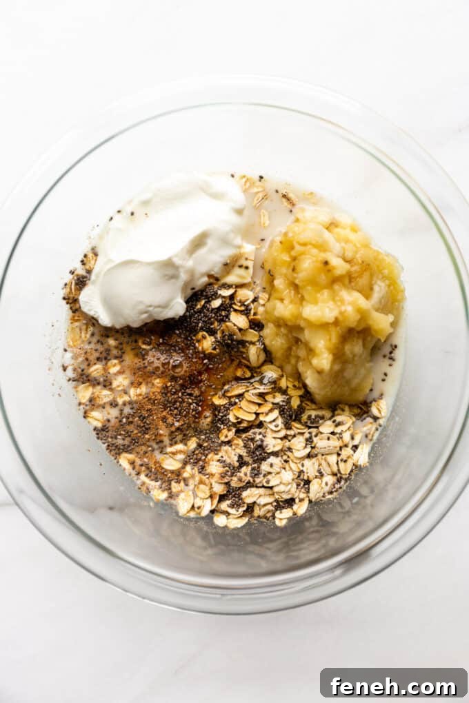 oats, chia seeds, nutmeg, yogurt, bananas and almond milk in a mixing bowl