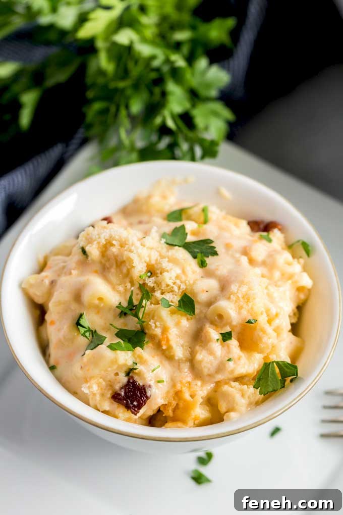 Homemade Mac and Cheese with bacon carbonara in a white bowl.