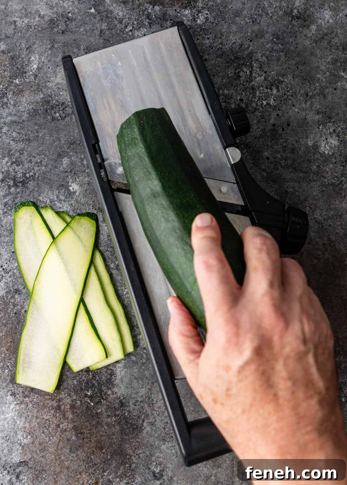 overhead: peeling zucchini with a vegetable mandoline