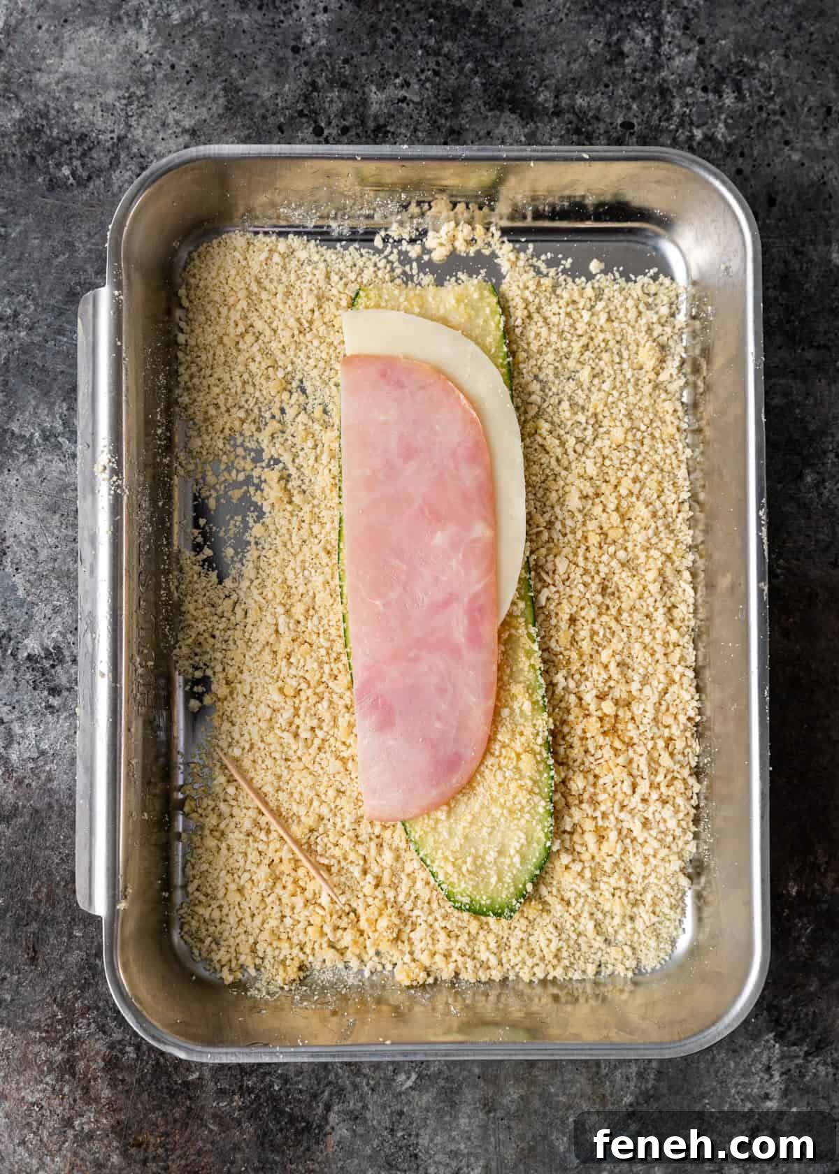 overhead process shot: wrapping the breaded zucchini with provolone and ham