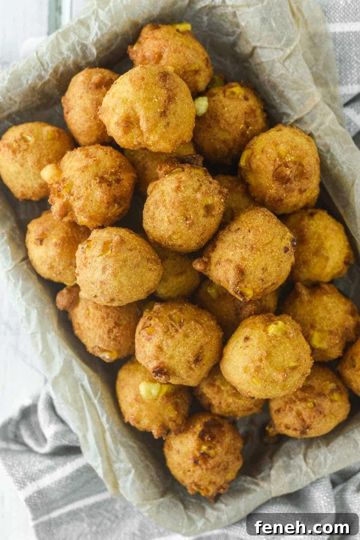 overhead shot of corn nuggets on parchment-lined metal tin