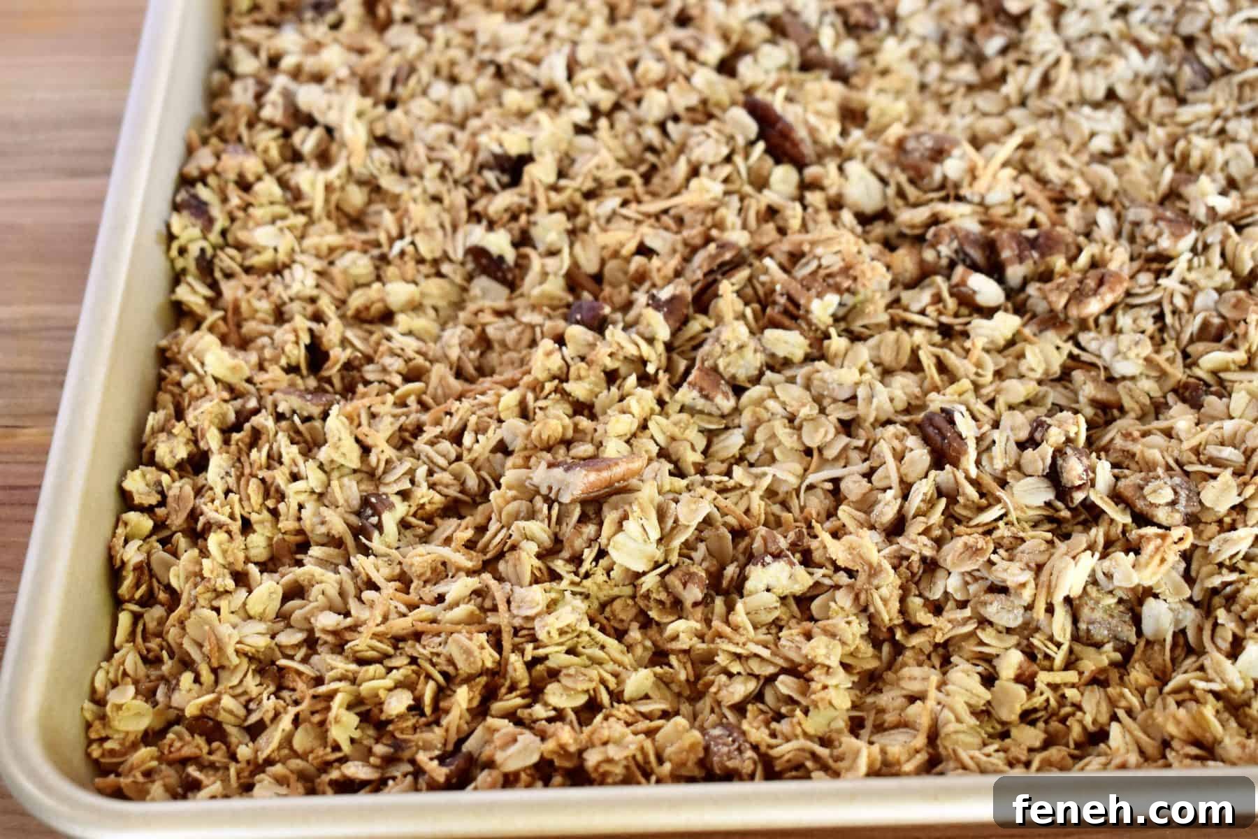 close up of coconut pecan granola in baking sheet. 