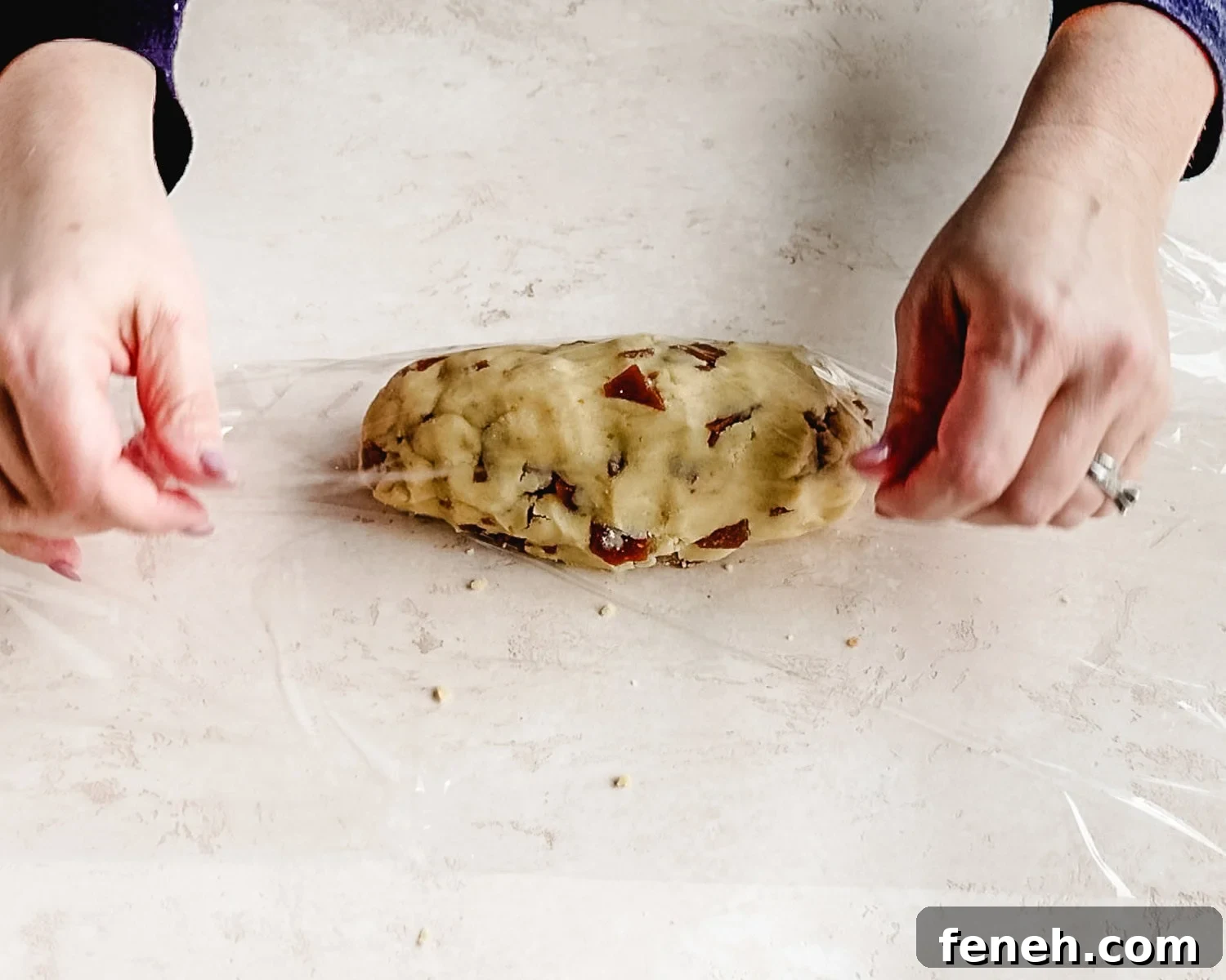 Wrap shortbread cookie dough log into plastic wrap.
