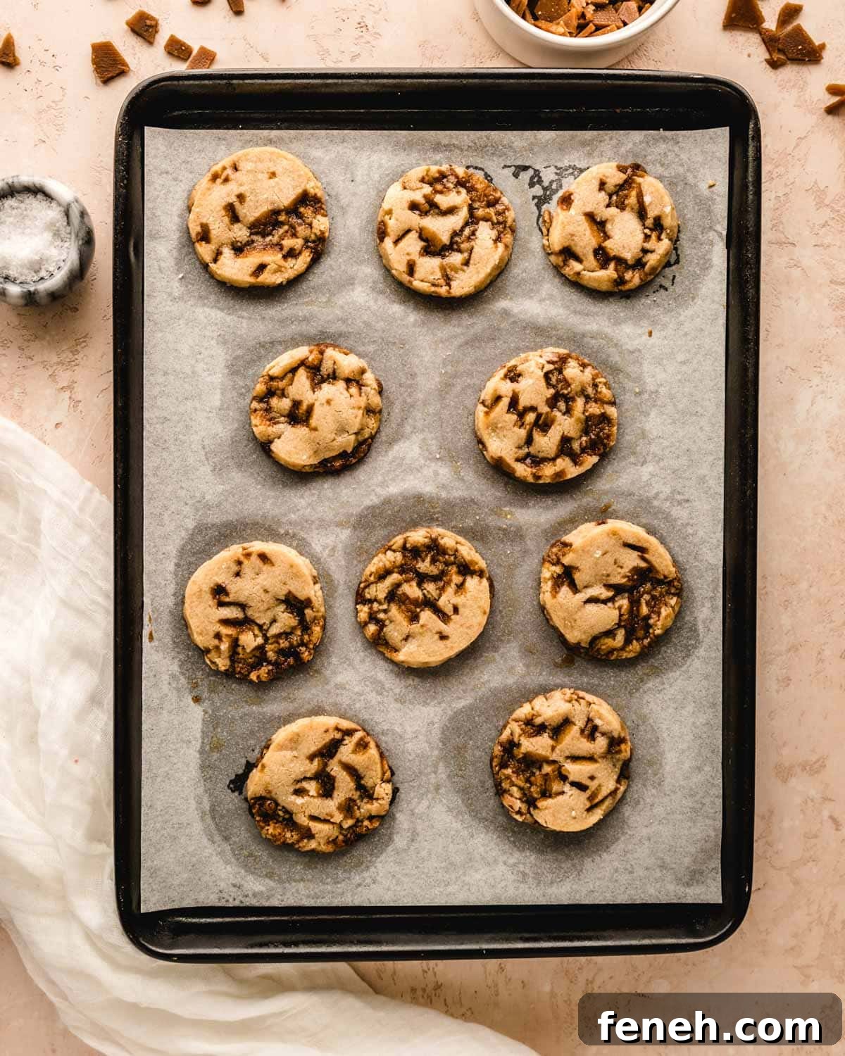 Freshly baked toffee shortbread cookies on a baking tray.