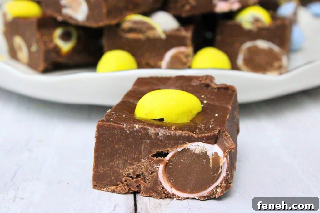 closeup of a mini egg fudge square in front of a plate of fudge