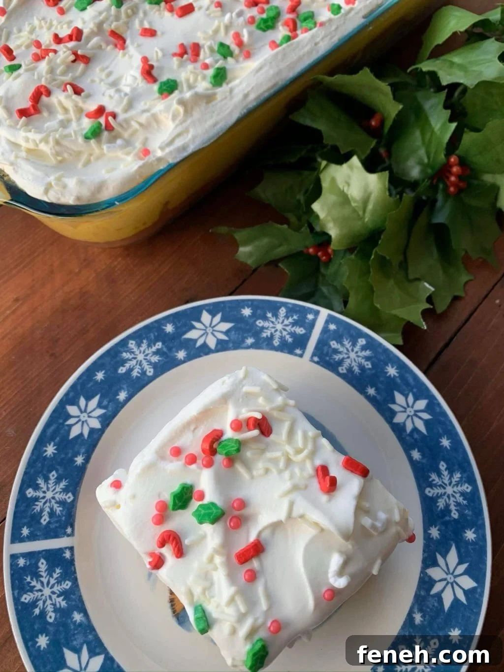 A slice of egg nog layer cake on a white and blue plate
