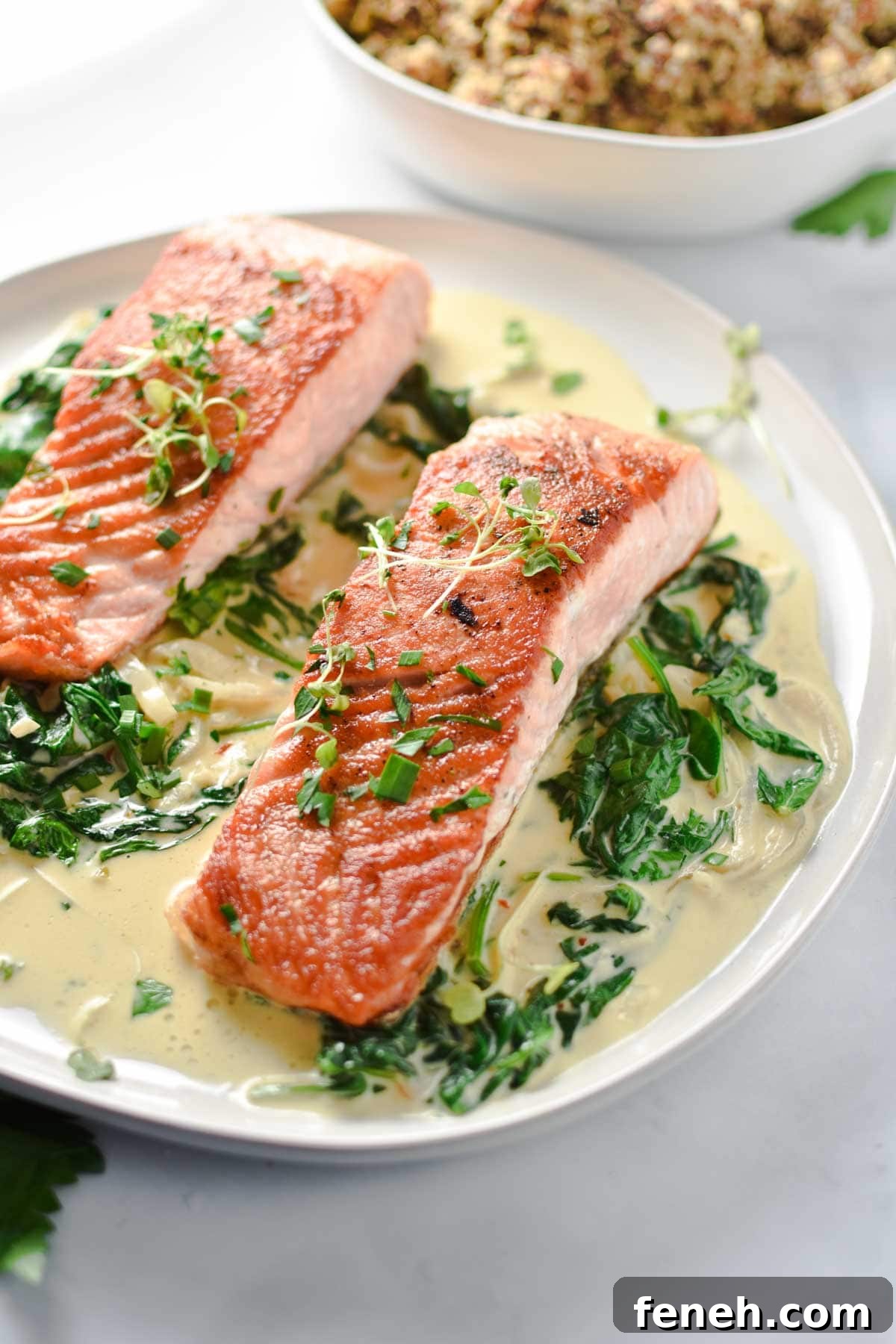Salmon on a plate topped with parsley and microgreens