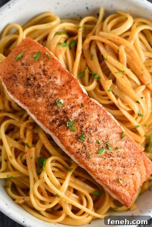 Cajun salmon pasta in a white bowl.