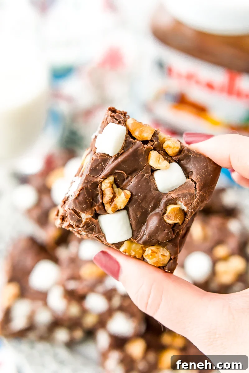 Nutella Rocky Road Fudge is perfect for Nutella and fudge lovers, alike! Loaded with marshmallows, walnuts, and chocolate chips, it’s an easy and delicious treat that everyone will love.