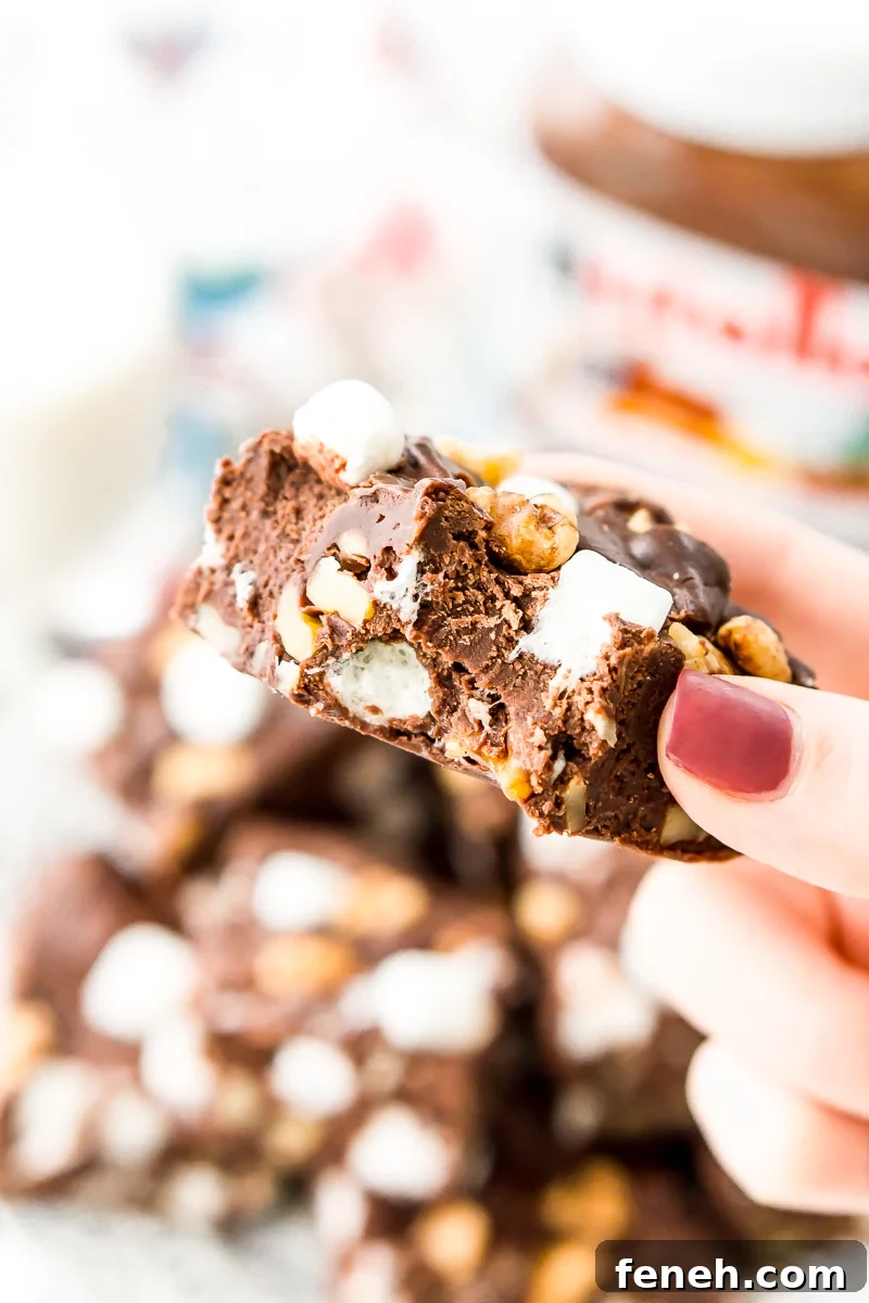 Nutella Rocky Road Fudge is perfect for Nutella and fudge lovers, alike! Loaded with marshmallows, walnuts, and chocolate chips, it’s an easy and delicious treat that everyone will love.