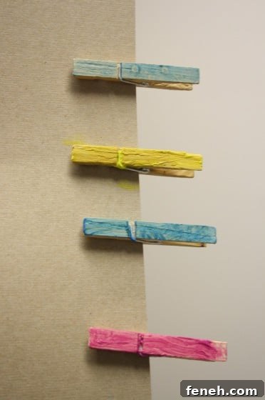 painted clothespins pinned to piece of cardboard