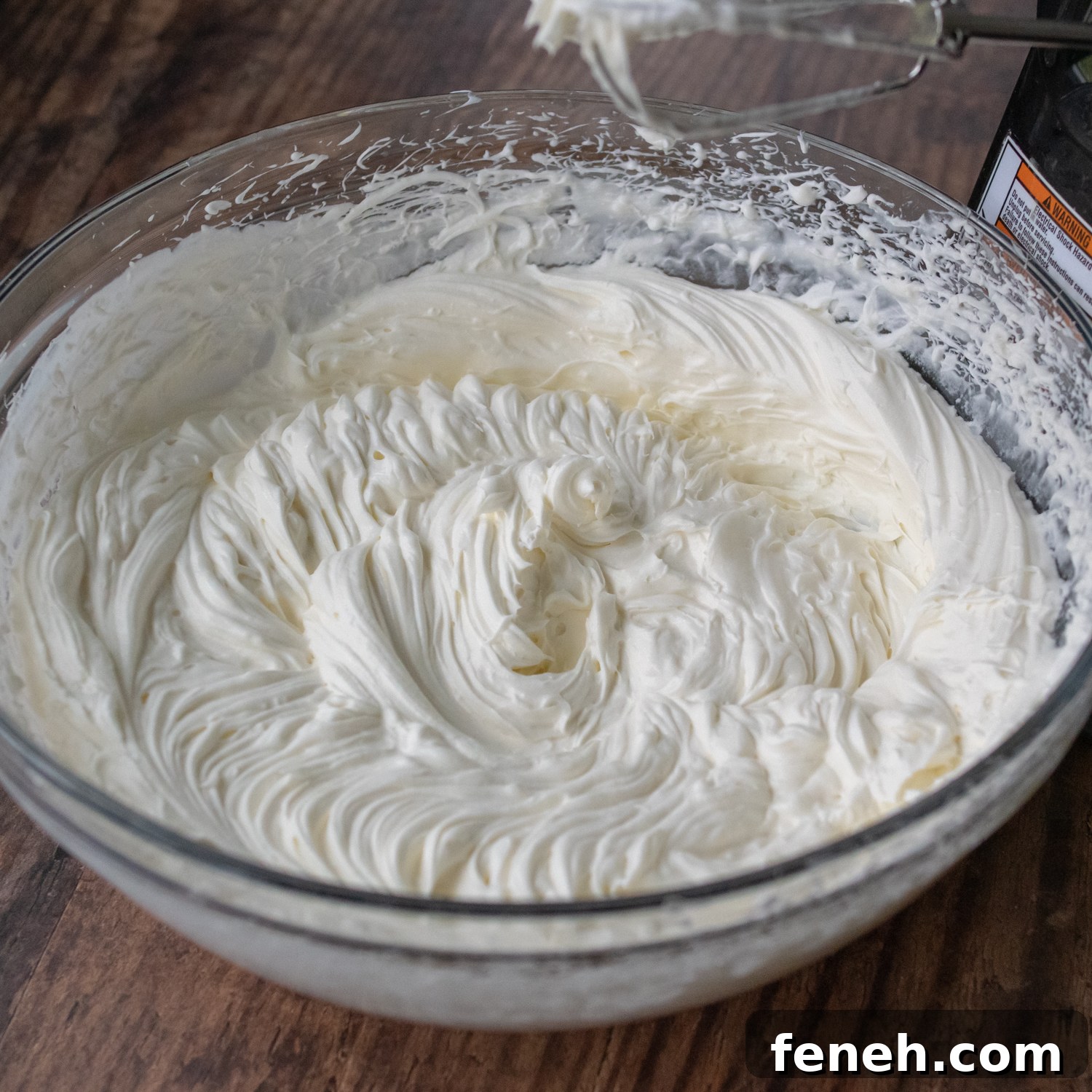the whipped cream cheese frosting a glass bowl.