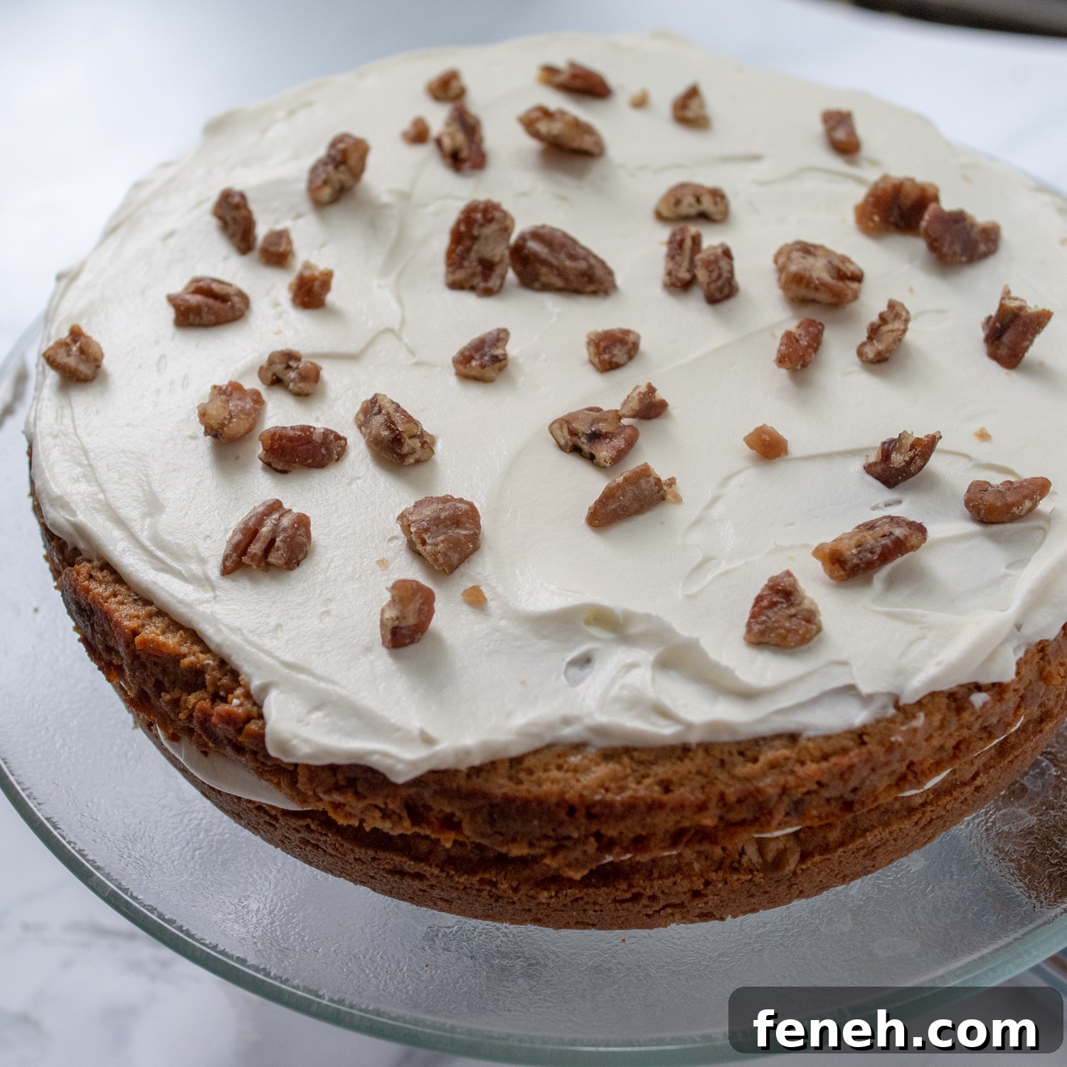 candied pecans on top a cake layer.