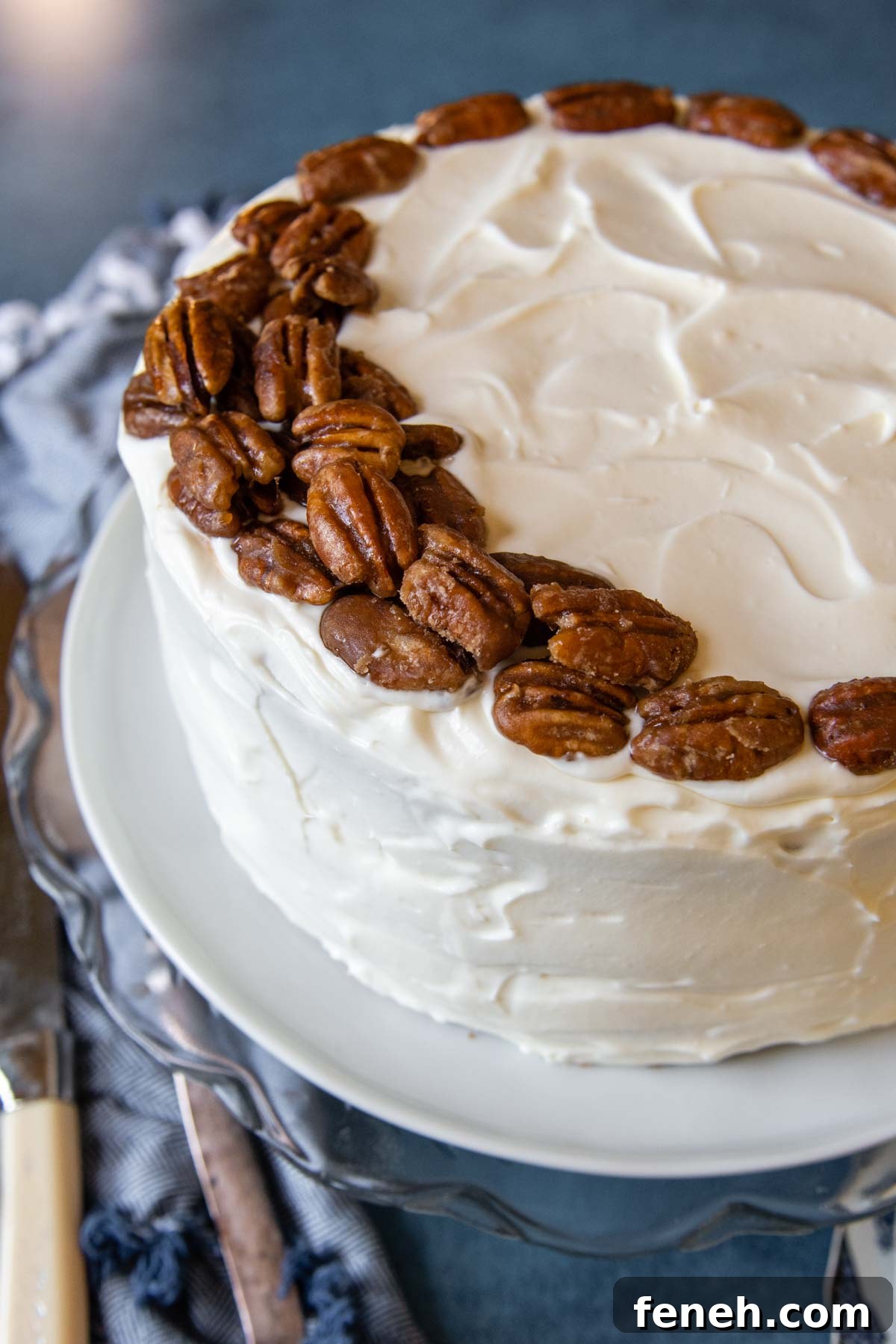 top of uncut cake with praline pecans on top.