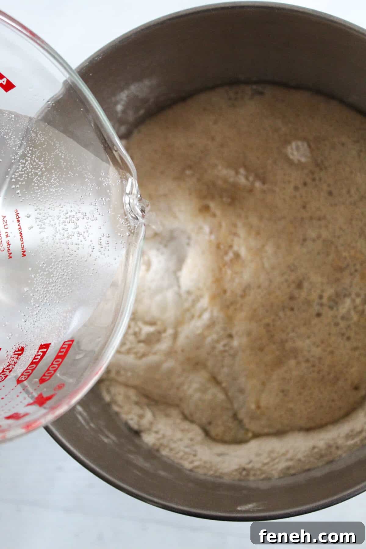 adding liquid to dry ingredients.