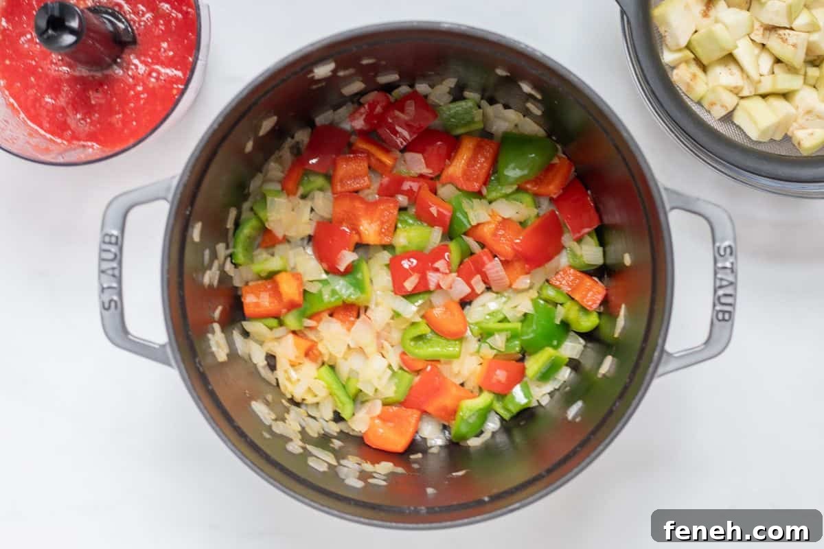 Sauteed onion, peppers, and herbs in large stock pan.