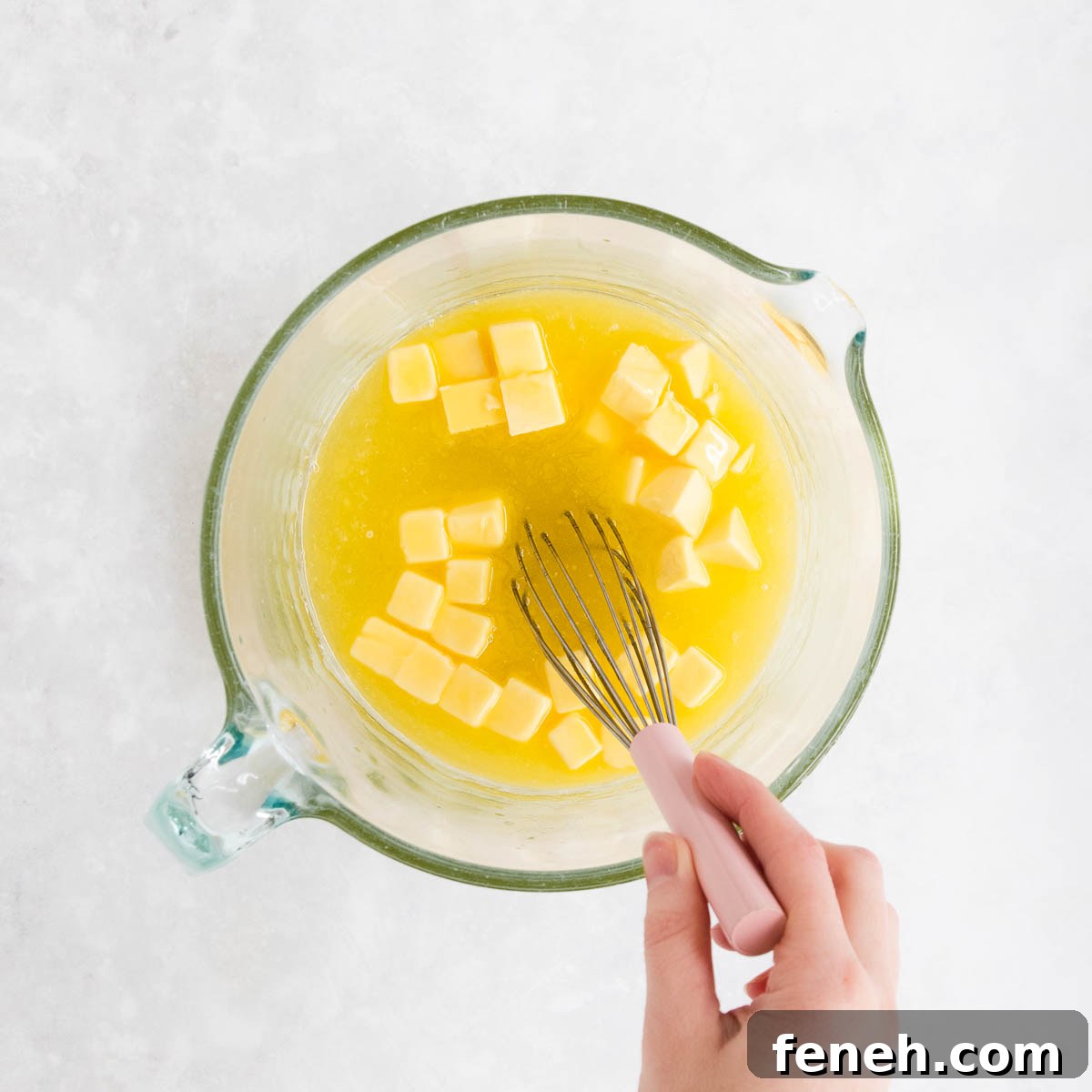Butter being added to the lemon/sugar mixture, and stirred as it starts to melt.