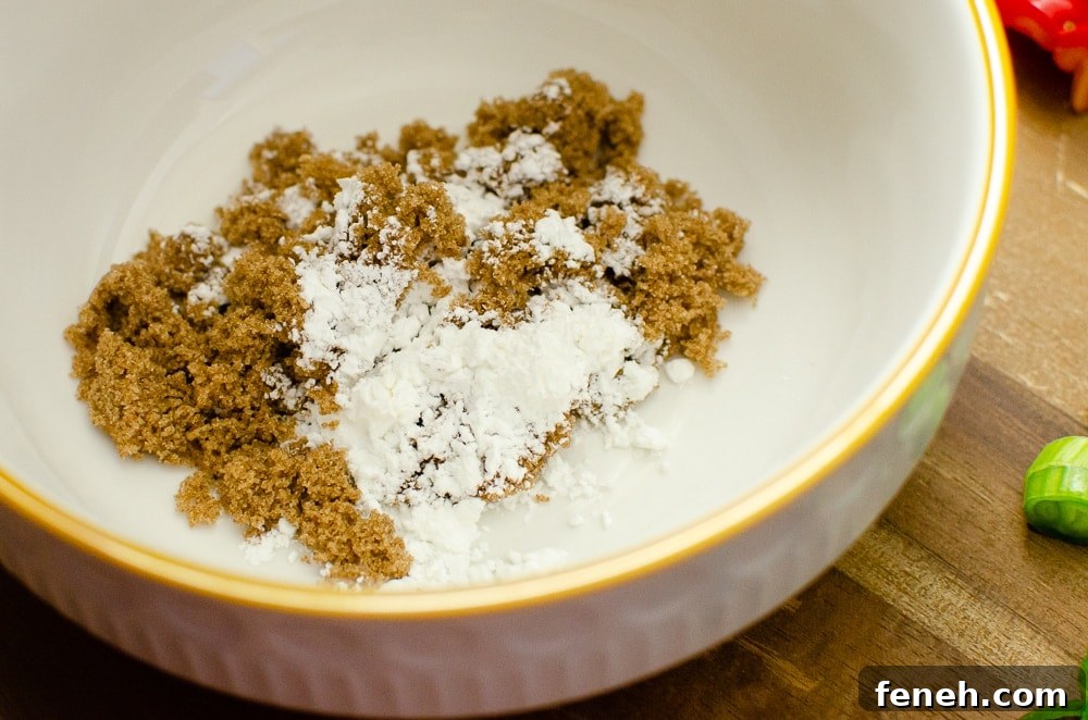 Dark brown sugar,ground ginger and cornflour in a white bowl