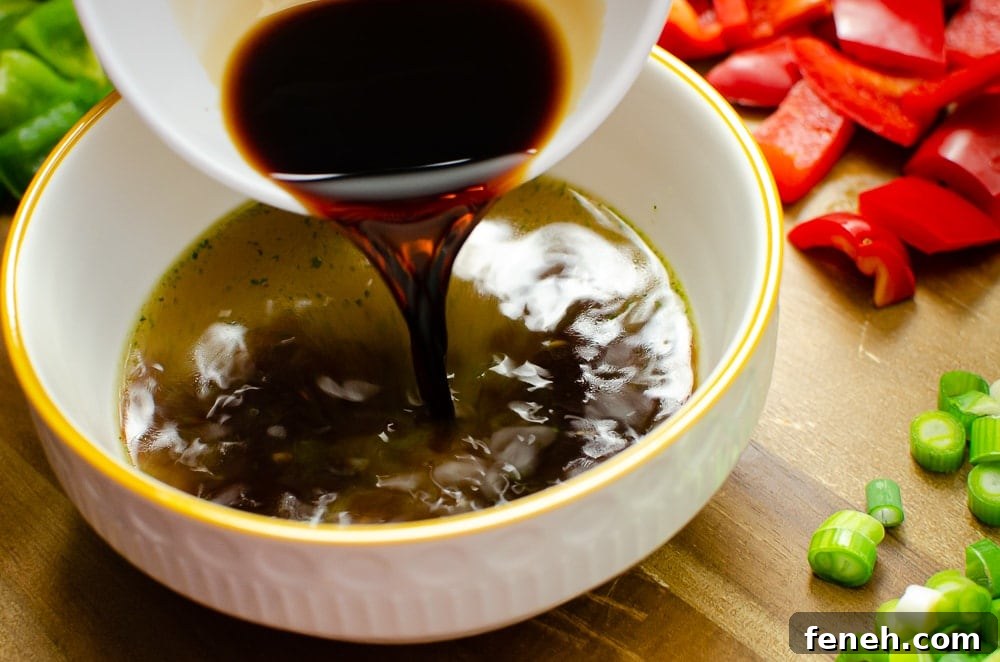 Light soy sauce being poured into a white bowl