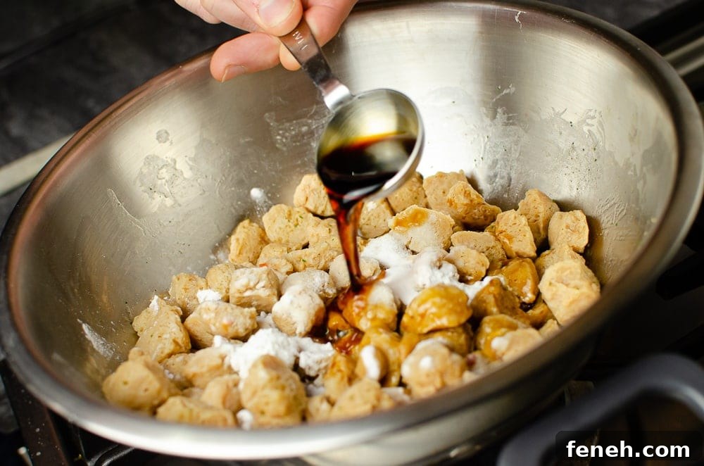 Soy Sauce being poured over the Textured Vegetable Protein