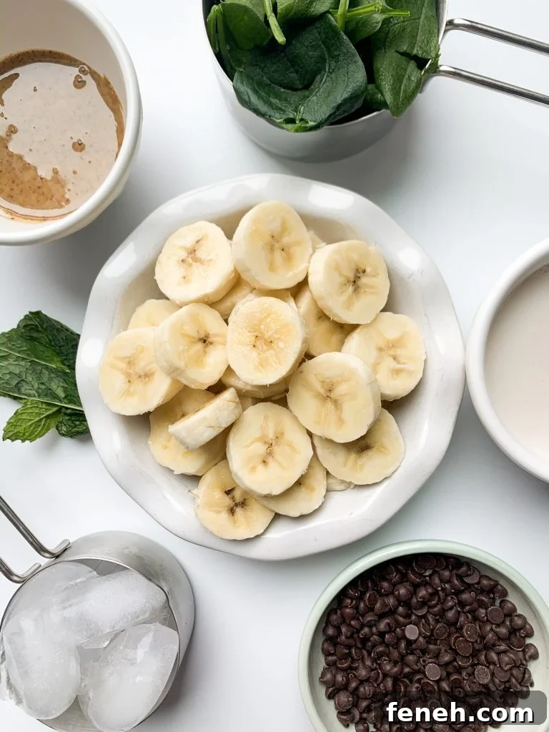 mint chip smoothie ingredients laid out on a white surface