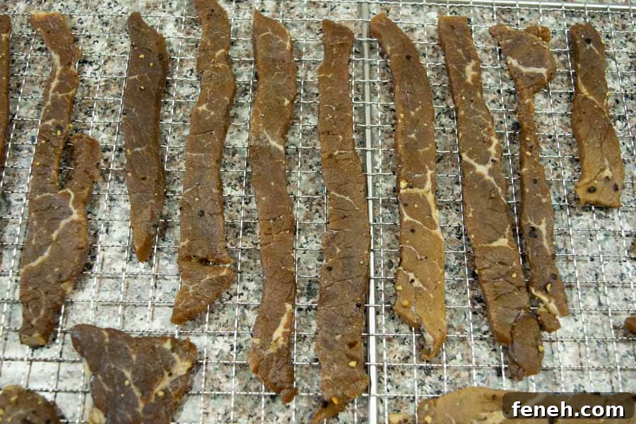 Zesty Lemon Pepper Beef Jerky: Tangy, Savory Snack Guide 13 Lemon pepper jerky on dehydrator trays ready to dry