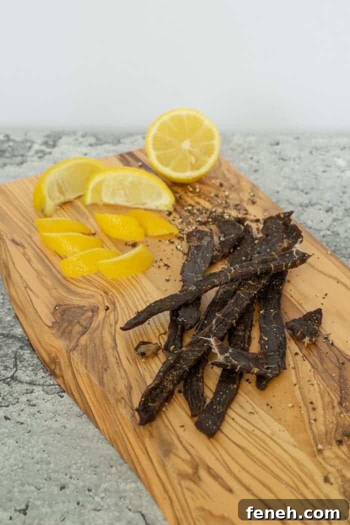 Zesty Lemon Pepper Beef Jerky: Tangy, Savory Snack Guide 17 Lemon Pepper Beef jerky on cutting board with lemons