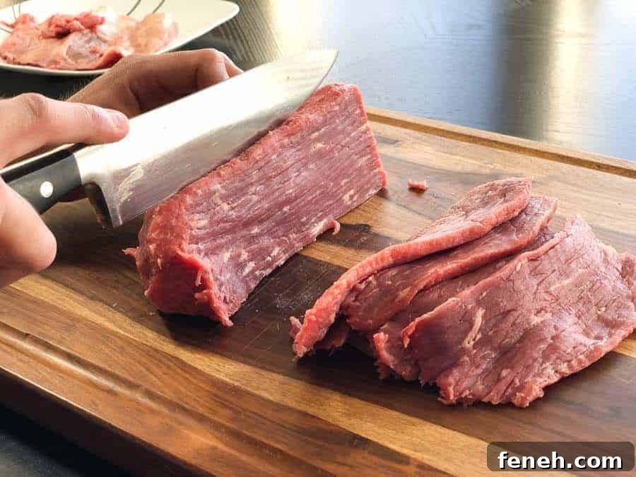 Zesty Lemon Pepper Beef Jerky: Tangy, Savory Snack Guide 7 Eye of round beef roast being sliced in cutting board