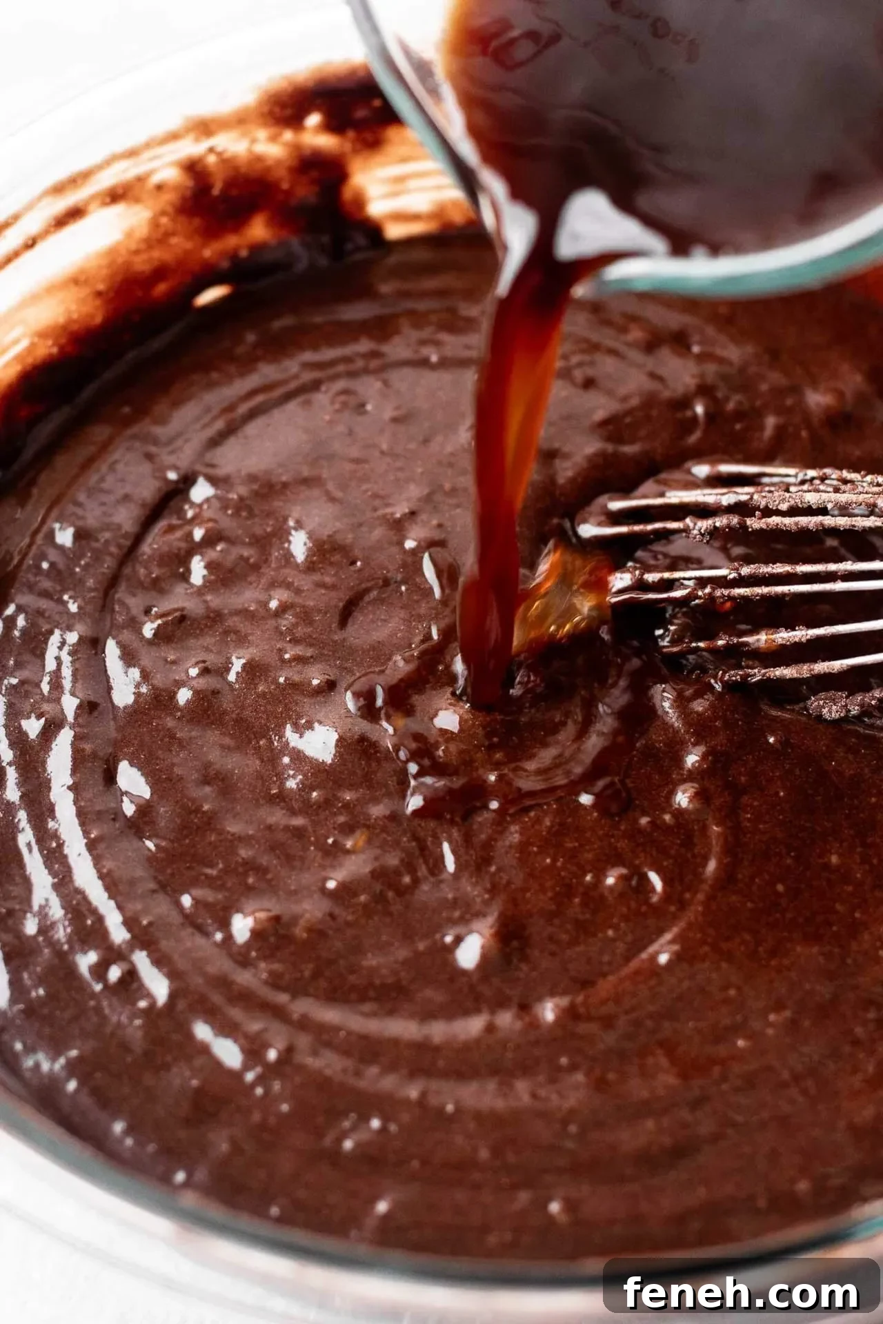 gluten free chocolate cake batter in bowl with cup of hot coffee being poured in