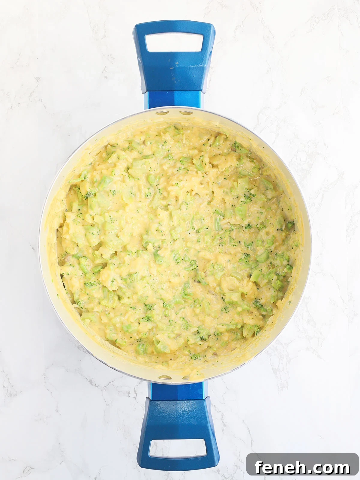 broccoli, rice, and cheese sauce mixed together in a large stock pot