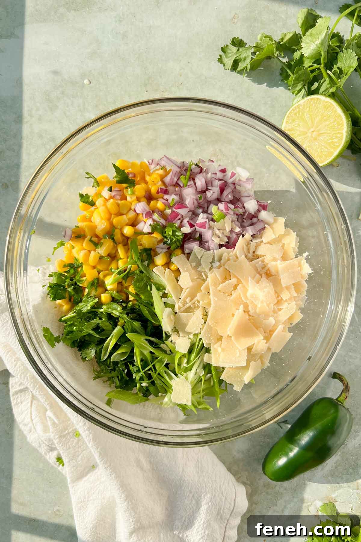 elote in a cup ingredients combined in a glass bowl before mixing.
